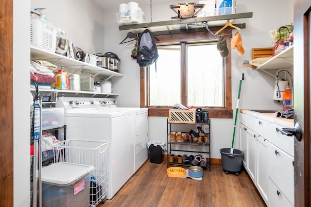 7170 29th Ave SW, Pequot Lakes, MN 56472 - laundry room featuring washer and clothes dryer, wood finished floors, and cabinet space