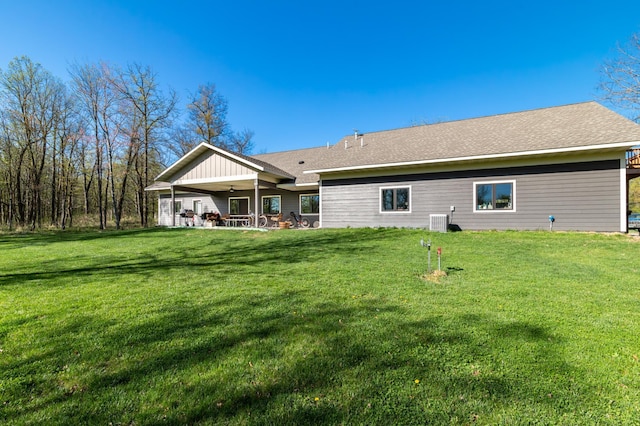 7170 29th Ave SW, Pequot Lakes, MN 56472 - back of property with a ceiling fan, a lawn, and a patio area