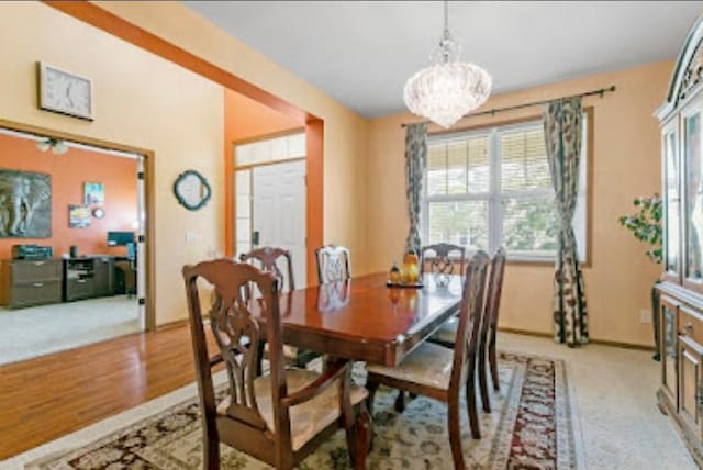 15850 Elmwood Ln, Apple Valley, MN 55124 - dining area with a chandelier, light wood finished floors, and light colored carpet