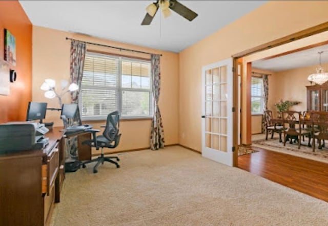 15850 Elmwood Ln, Apple Valley, MN 55124 - office area featuring carpet floors, a ceiling fan, a chandelier, and french doors