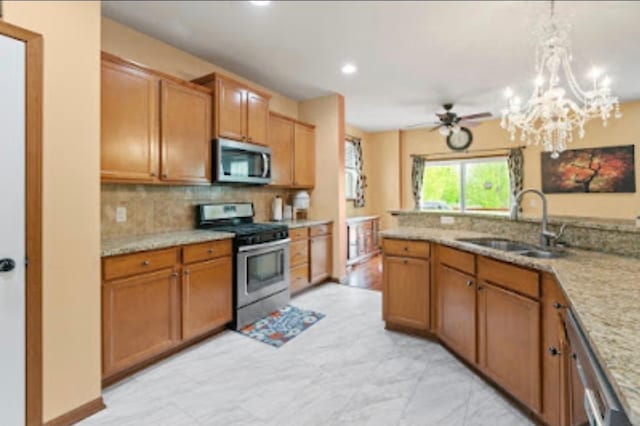 15850 Elmwood Ln, Apple Valley, MN 55124 - kitchen featuring appliances with stainless steel finishes, decorative backsplash, a chandelier, light marble finish floors, and brown cabinetry