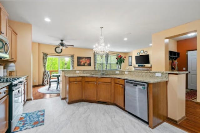 15850 Elmwood Ln, Apple Valley, MN 55124 - kitchen featuring stainless steel appliances, a chandelier, open floor plan, light stone counters, and brown cabinetry
