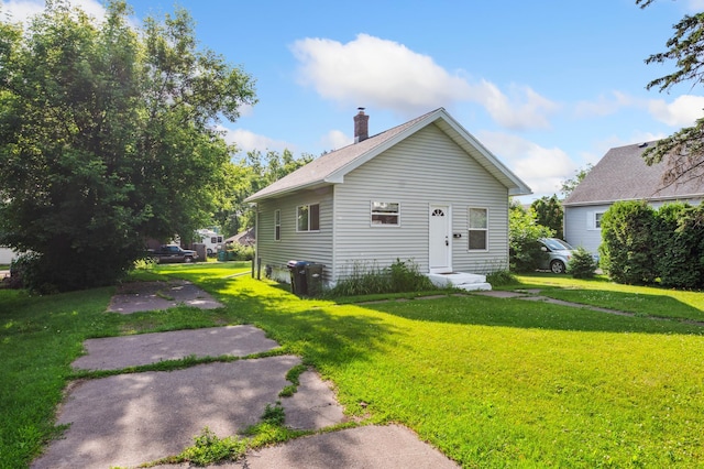 14 15th St, Cloquet, MN 55720 - bungalow-style home featuring a front yard and a chimney