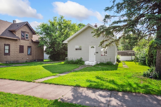 14 15th St, Cloquet, MN 55720 - view of front of property with a front yard and a chimney