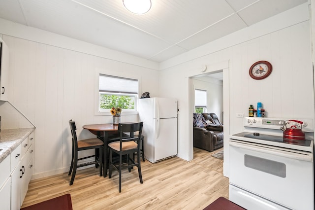 14 15th St, Cloquet, MN 55720 - kitchen featuring white appliances, plenty of natural light, and light wood-style floors