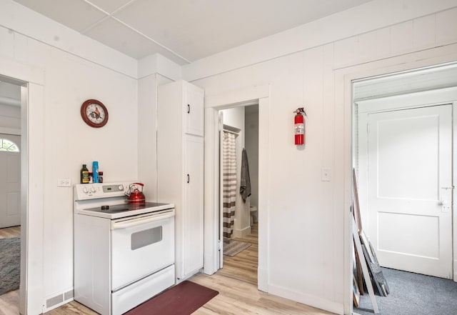 14 15th St, Cloquet, MN 55720 - kitchen with white range with electric cooktop, white cabinets, and light wood-style floors