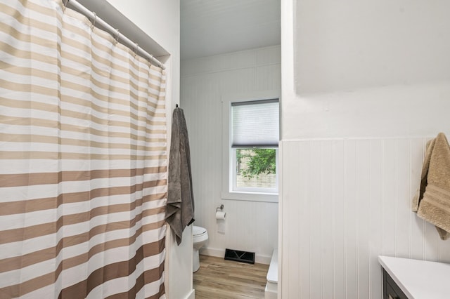 14 15th St, Cloquet, MN 55720 - bathroom with wood finished floors, vanity, and a shower with curtain