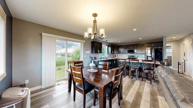 1280 Lone Stone Ct SE, Chatfield, MN 55923 - dining area with a chandelier, light wood-style flooring, and recessed lighting