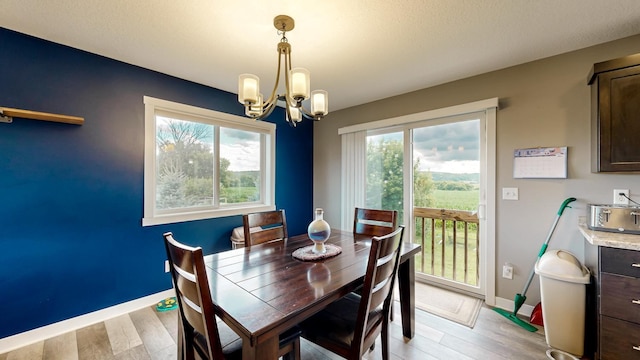 1280 Lone Stone Ct SE, Chatfield, MN 55923 - dining area featuring a chandelier and light wood-style floors
