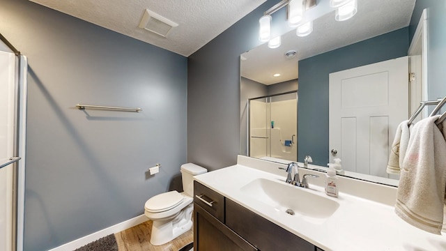 1280 Lone Stone Ct SE, Chatfield, MN 55923 - bathroom with wood finished floors, a shower, vanity, and a textured ceiling