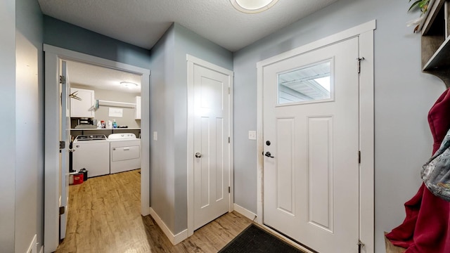 1280 Lone Stone Ct SE, Chatfield, MN 55923 - foyer featuring separate washer and dryer, light wood-style flooring, and a textured ceiling