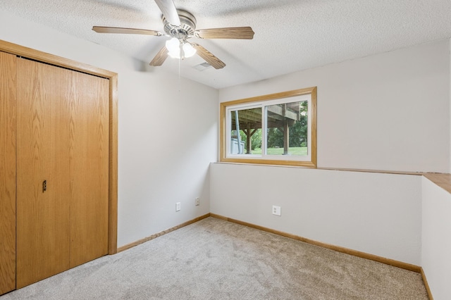 11716 54th St NE, Albertville, MN 55301 - unfurnished bedroom with a closet, carpet, a textured ceiling, and a ceiling fan