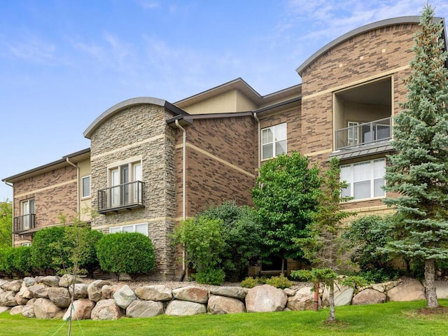 13580 Technology Dr Unit 3306, Eden Prairie, MN 55344 - view of property exterior with a balcony, brick siding, and stone siding