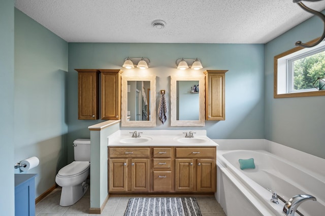 11259 69th St NE, Albertville, MN 55301 - bathroom with double vanity, a garden tub, a textured ceiling, and tile patterned flooring