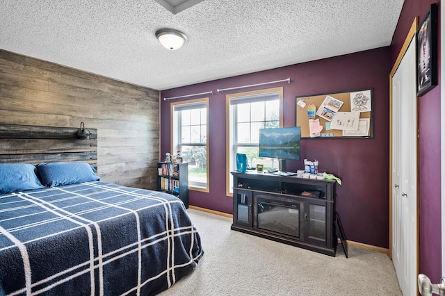 11259 69th St NE, Albertville, MN 55301 - carpeted bedroom with wood walls, a textured ceiling, and an accent wall