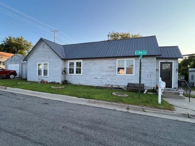 102 4th St S, Grove City, MN 56243 - view of front of home with a front yard and a metal roof