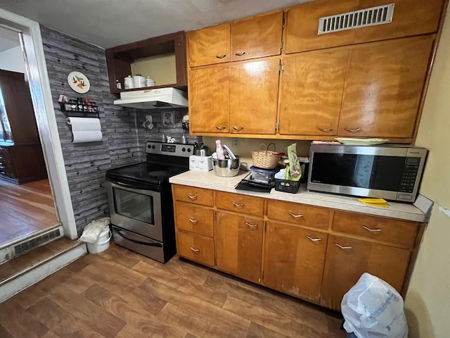 102 4th St S, Grove City, MN 56243 - kitchen featuring stainless steel appliances, extractor fan, light countertops, and brown cabinetry