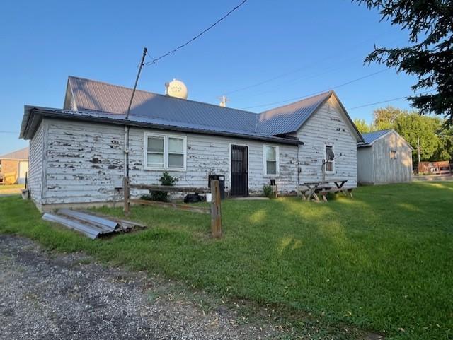 102 4th St S, Grove City, MN 56243 - back of property featuring a lawn and a metal roof