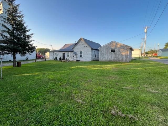 102 4th St S, Grove City, MN 56243 - rear view of property featuring a lawn