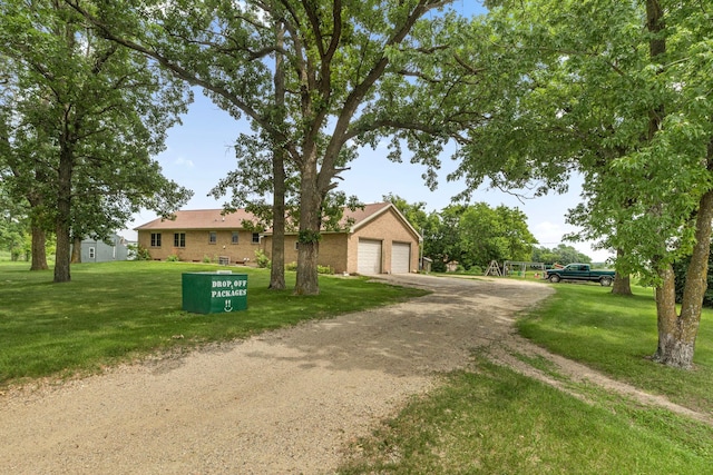43054 105th Ave, Brockway Twp, MN 56367 - view of front of home with brick siding, a front lawn, a detached garage, and driveway