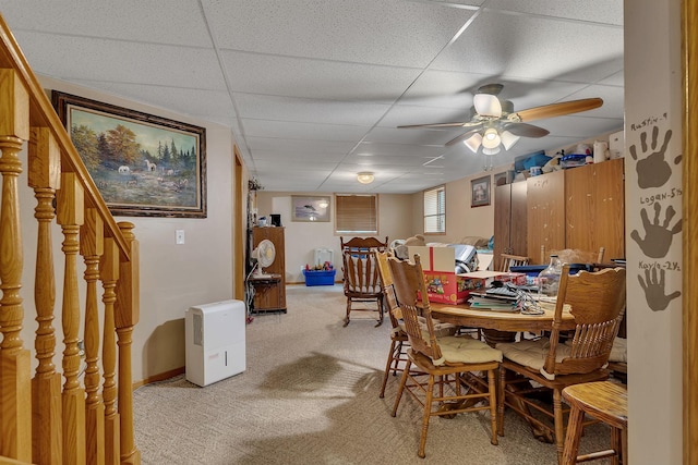 43054 105th Ave, Brockway Twp, MN 56367 - dining area with light colored carpet, a drop ceiling, ceiling fan, and stairway
