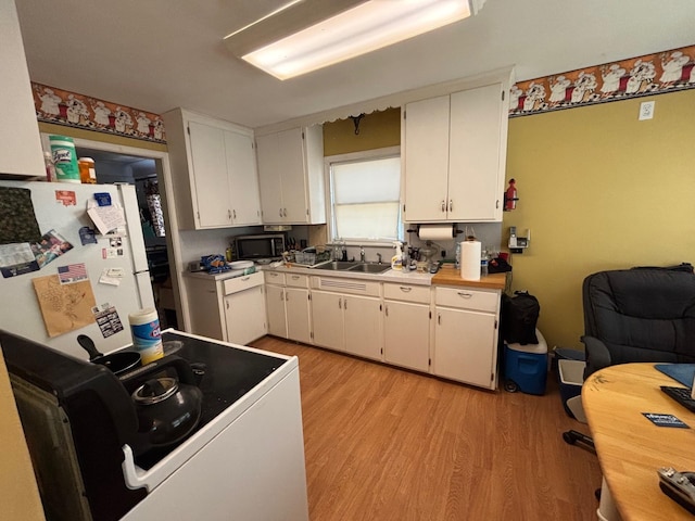 7145 Nicollet Ave S, Richfield, MN 55423 - kitchen featuring light wood-style flooring, range, white cabinets, light countertops, and stainless steel microwave
