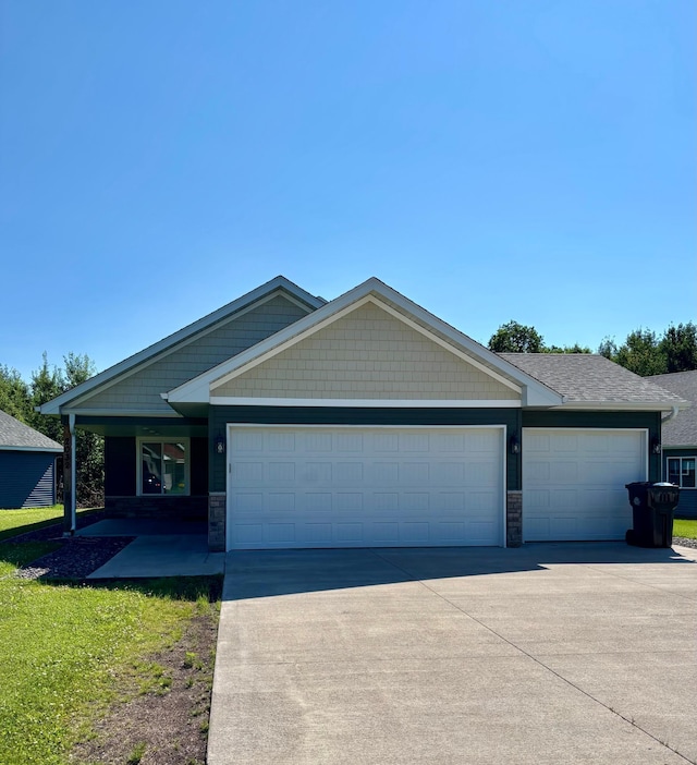 2032 Reuss Pkwy, Saint Croix Falls, WI 54024 - craftsman-style house with a garage and driveway