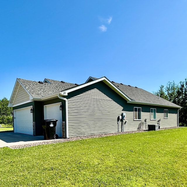 2032 Reuss Pkwy, Saint Croix Falls, WI 54024 - view of side of property featuring an attached garage, driveway, a lawn, and roof with shingles