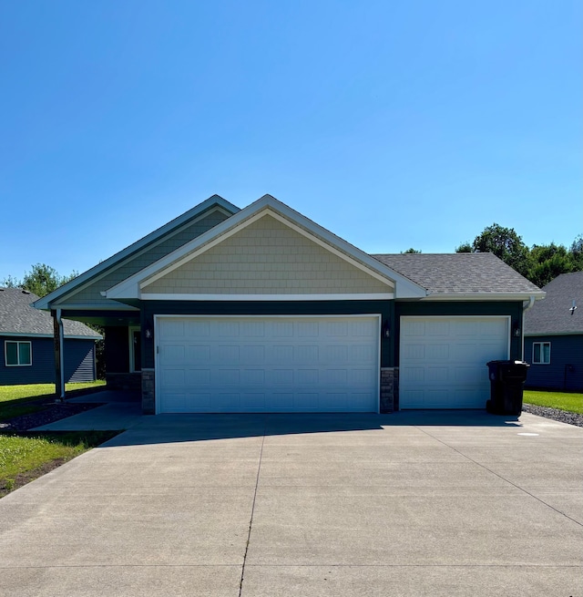 2032 Reuss Pkwy, Saint Croix Falls, WI 54024 - view of front of property with driveway, an attached garage, and stone siding