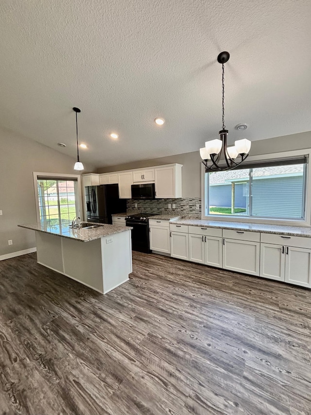 2032 Reuss Pkwy, Saint Croix Falls, WI 54024 - kitchen featuring black appliances, a textured ceiling, white cabinetry, tasteful backsplash, and dark wood finished floors