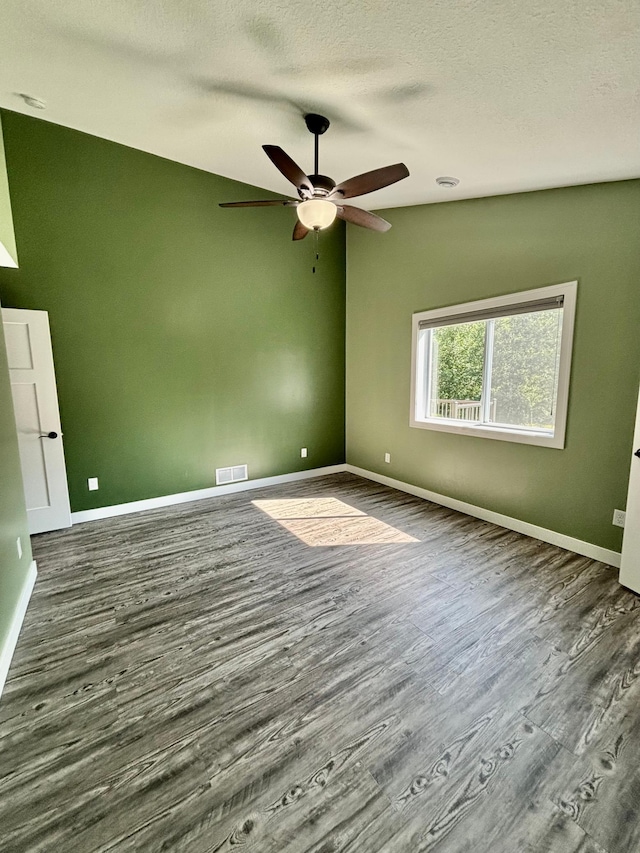 2032 Reuss Pkwy, Saint Croix Falls, WI 54024 - spare room with wood finished floors, a ceiling fan, and a textured ceiling