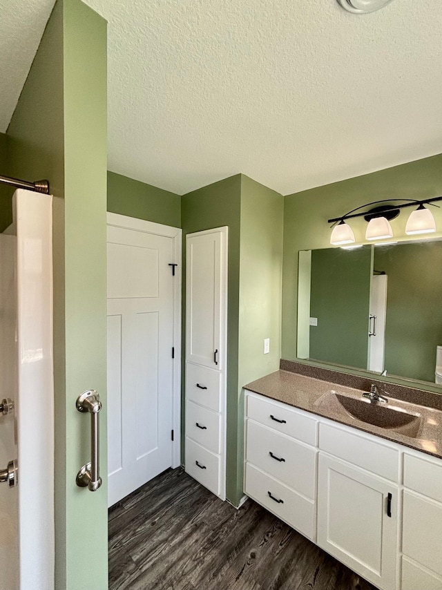 2032 Reuss Pkwy, Saint Croix Falls, WI 54024 - bathroom featuring wood finished floors, vanity, and a textured ceiling