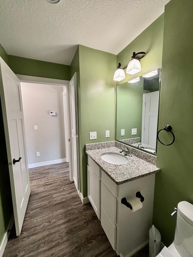 2032 Reuss Pkwy, Saint Croix Falls, WI 54024 - bathroom featuring wood finished floors, vanity, and a textured ceiling