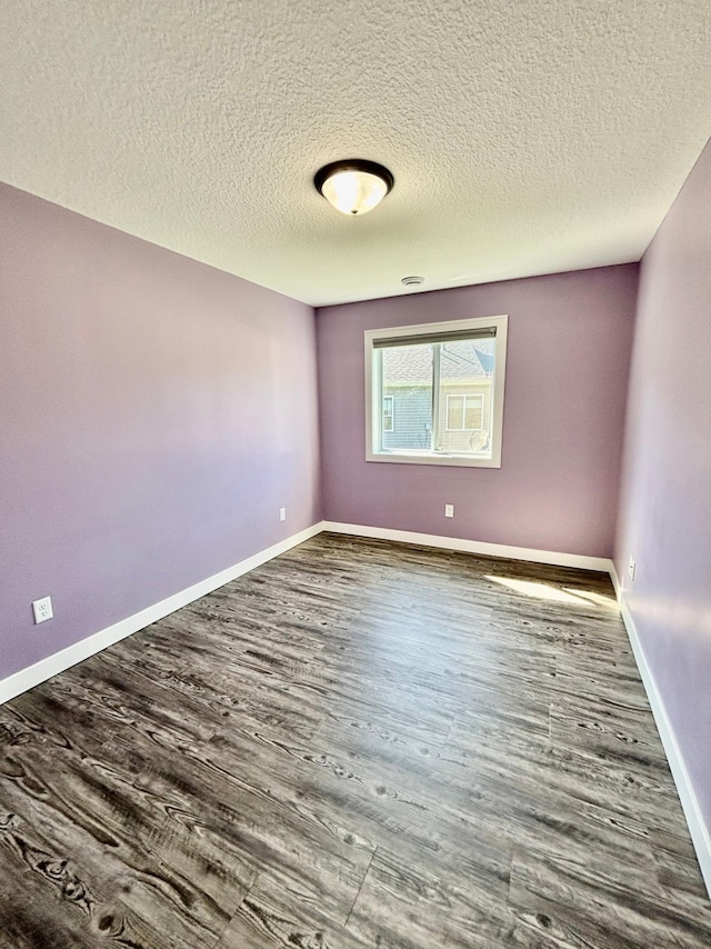 2032 Reuss Pkwy, Saint Croix Falls, WI 54024 - empty room featuring a textured ceiling and wood finished floors