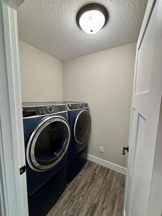 2032 Reuss Pkwy, Saint Croix Falls, WI 54024 - washroom featuring washing machine and clothes dryer, dark wood finished floors, and a textured ceiling