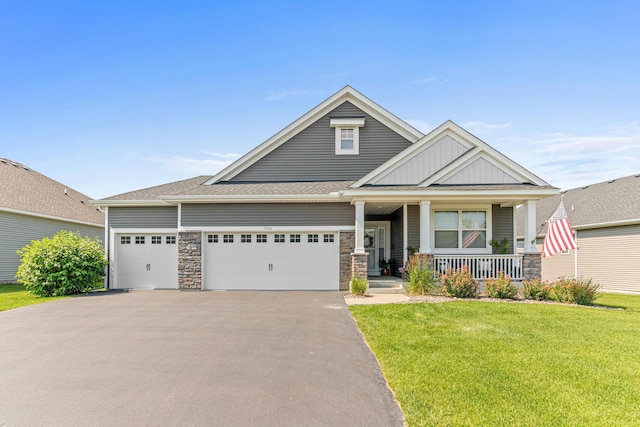 19621 115th Ave N, Rogers, MN 55311 - craftsman inspired home with stone siding, a porch, a garage, asphalt driveway, and a front lawn
