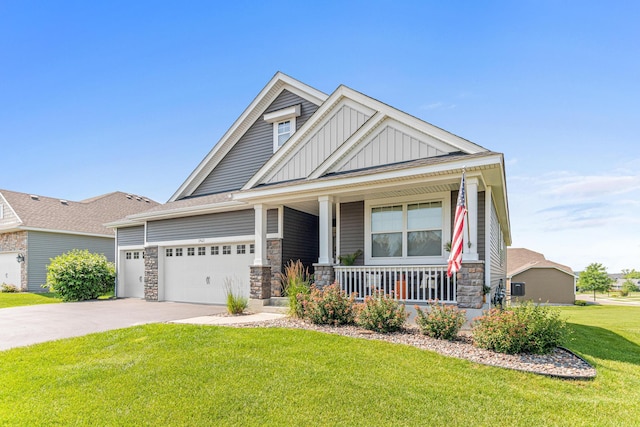19621 115th Ave N, Rogers, MN 55311 - craftsman inspired home featuring stone siding, a porch, board and batten siding, a garage, and driveway