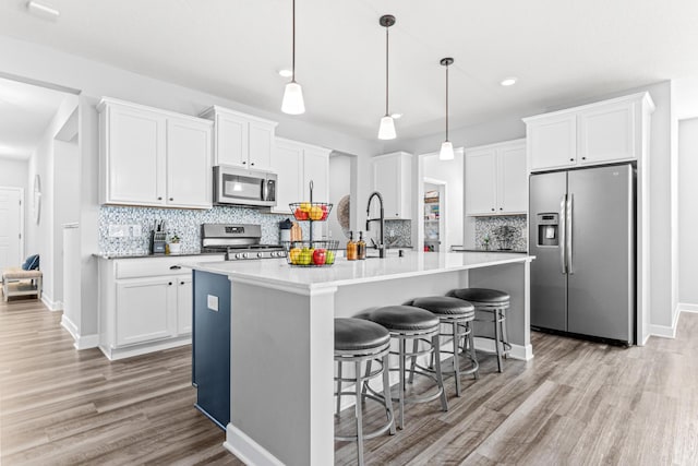 19621 115th Ave N, Rogers, MN 55311 - kitchen with appliances with stainless steel finishes, light wood-style flooring, decorative backsplash, and recessed lighting