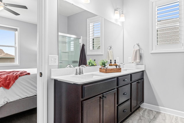 19621 115th Ave N, Rogers, MN 55311 - bathroom with ensuite bathroom, double vanity, a shower with door, ceiling fan, and marble finish floors
