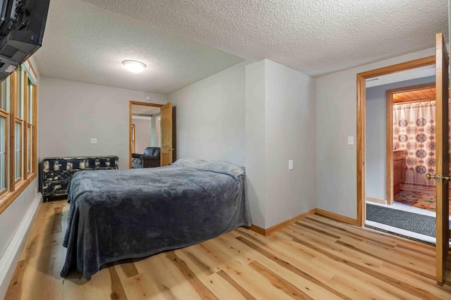 12639 65th Ave SW, May Twp, MN 56466 - bedroom with wood finished floors and a textured ceiling