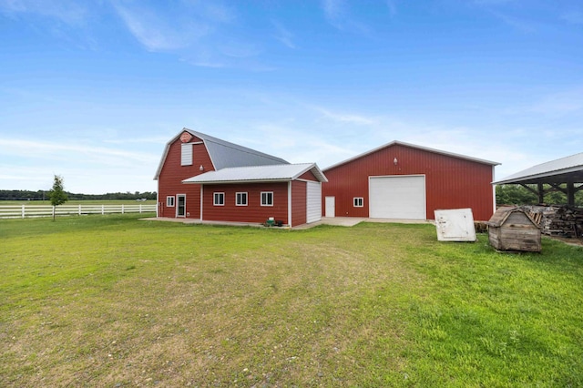 12639 65th Ave SW, May Twp, MN 56466 - back of house featuring an outdoor structure, a detached garage, a barn, a gambrel roof, and driveway