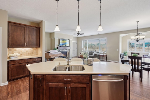 7461 Fir Ln N, Corcoran, MN 55340 - kitchen with stainless steel dishwasher, dark wood finished floors, light countertops, and open floor plan