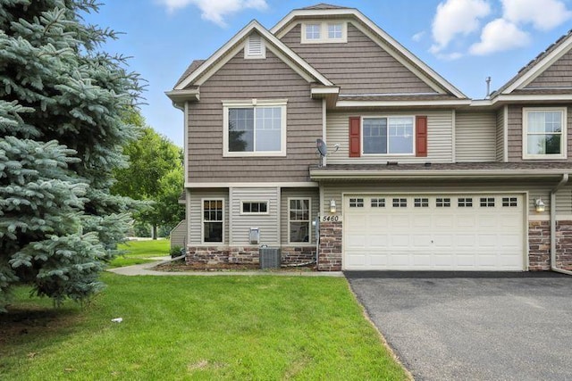 5460 100th Ln N, Brooklyn Park, MN 55443 - craftsman house with asphalt driveway, a garage, and a front yard