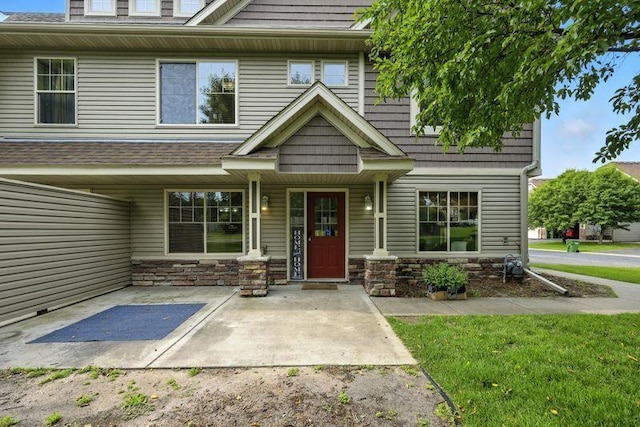 5460 100th Ln N, Brooklyn Park, MN 55443 - view of front facade featuring stone siding and covered porch