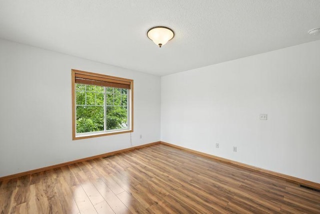 5460 100th Ln N, Brooklyn Park, MN 55443 - spare room with wood finished floors and baseboards