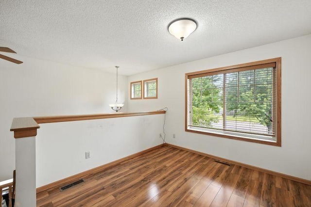 5460 100th Ln N, Brooklyn Park, MN 55443 - unfurnished room with wood finished floors, a textured ceiling, and a ceiling fan