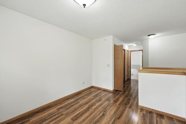 5460 100th Ln N, Brooklyn Park, MN 55443 - empty room with dark wood-style floors and a textured ceiling