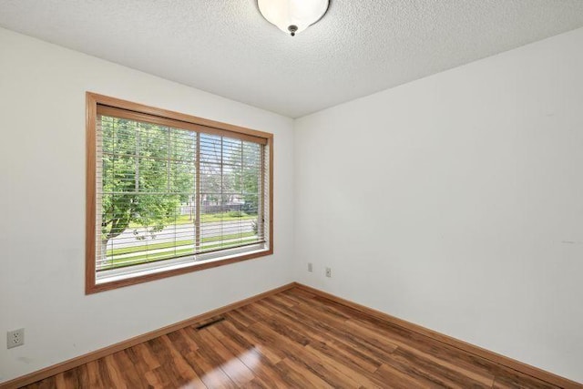 5460 100th Ln N, Brooklyn Park, MN 55443 - unfurnished room with wood finished floors and a textured ceiling