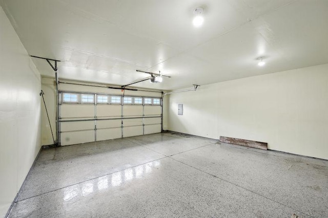 5460 100th Ln N, Brooklyn Park, MN 55443 - garage featuring a garage door opener and baseboards