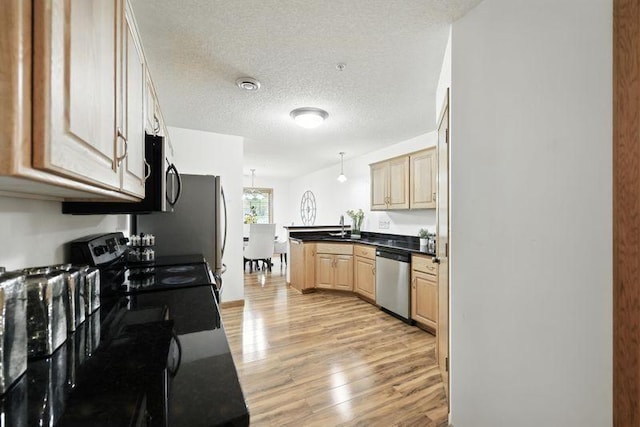 5460 100th Ln N, Brooklyn Park, MN 55443 - kitchen featuring stainless steel appliances, light wood-style floors, a peninsula, light brown cabinetry, and a textured ceiling